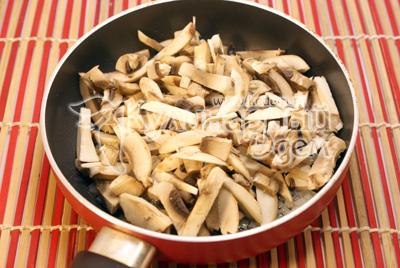 Добавить соломкой нарезанные грибы шампиньоны и обжаривать 2-3 минуты. Посолить