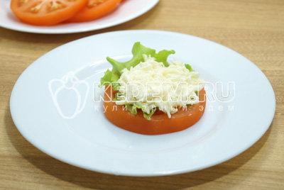 На кружок помидора выложить листик салата и ложку сырной начинки.
