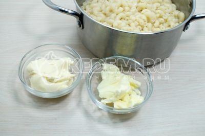 Горячие макароны вернуть в кастрюлю, добавить 30 грамм сливочного масла и 30 грамм плавленого сыра.
