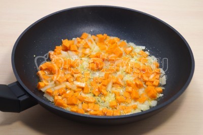 На сковороде обжарить лук и морковь, помешивая, 2-3 минуты.